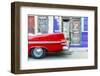 A red vintage car parked against colourful local architecture in Havana, Cuba-Chris Mouyiaris-Framed Photographic Print