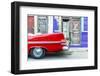 A red vintage car parked against colourful local architecture in Havana, Cuba-Chris Mouyiaris-Framed Photographic Print