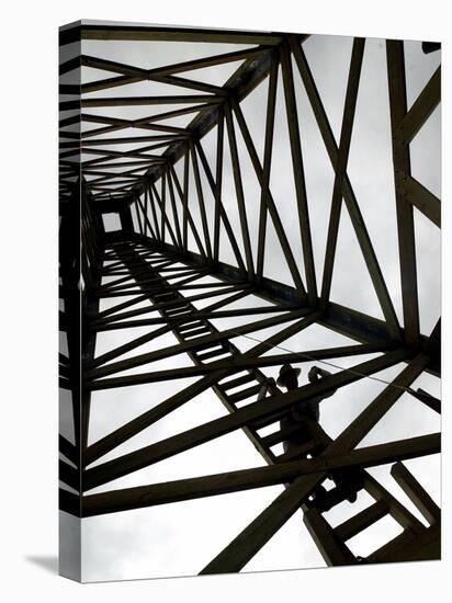 A Reenactor is Silhouetted Inside a Replica of the Spindletop Oil Derrick-null-Stretched Canvas