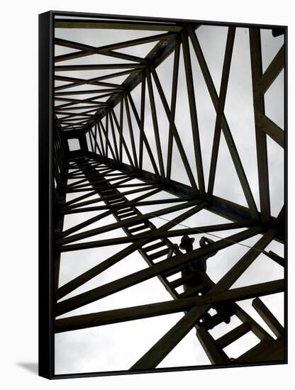 A Reenactor is Silhouetted Inside a Replica of the Spindletop Oil Derrick-null-Framed Stretched Canvas
