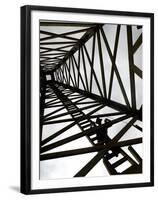 A Reenactor is Silhouetted Inside a Replica of the Spindletop Oil Derrick-null-Framed Premium Photographic Print