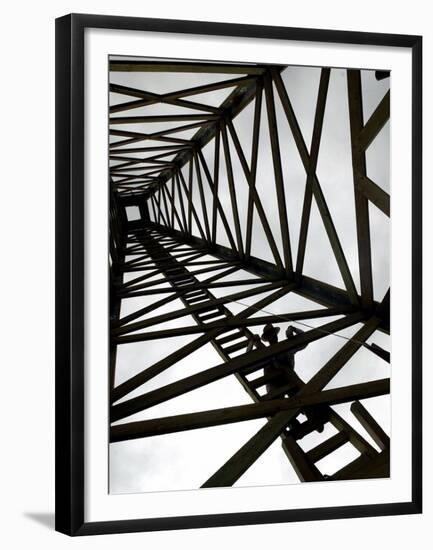 A Reenactor is Silhouetted Inside a Replica of the Spindletop Oil Derrick-null-Framed Premium Photographic Print