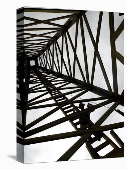 A Reenactor is Silhouetted Inside a Replica of the Spindletop Oil Derrick-null-Stretched Canvas