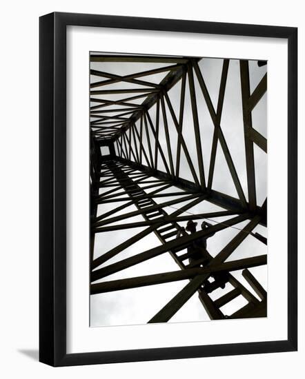 A Reenactor is Silhouetted Inside a Replica of the Spindletop Oil Derrick-null-Framed Photographic Print