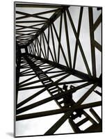 A Reenactor is Silhouetted Inside a Replica of the Spindletop Oil Derrick-null-Mounted Photographic Print