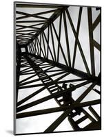 A Reenactor is Silhouetted Inside a Replica of the Spindletop Oil Derrick-null-Mounted Photographic Print