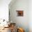 A Rich Wooden Wall with Rustic Tools and Window and a Stone Wall-null-Stretched Canvas displayed on a wall
