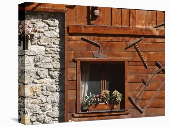 A Rich Wooden Wall with Rustic Tools and Window and a Stone Wall-null-Stretched Canvas