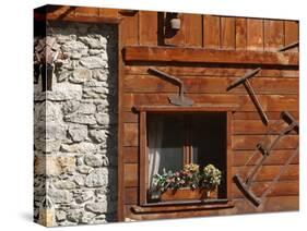 A Rich Wooden Wall with Rustic Tools and Window and a Stone Wall-null-Stretched Canvas
