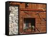 A Rich Wooden Wall with Rustic Tools and Window and a Stone Wall-null-Framed Stretched Canvas