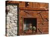 A Rich Wooden Wall with Rustic Tools and Window and a Stone Wall-null-Stretched Canvas