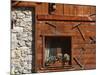 A Rich Wooden Wall with Rustic Tools and Window and a Stone Wall-null-Mounted Photographic Print