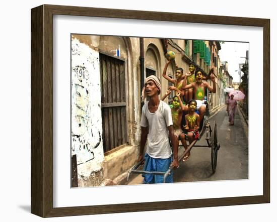 A Rickshaw Puller Carries Supporters of Brazil Soccer Team-null-Framed Photographic Print