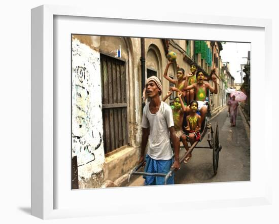 A Rickshaw Puller Carries Supporters of Brazil Soccer Team-null-Framed Photographic Print