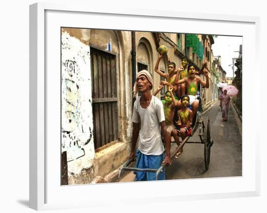 A Rickshaw Puller Carries Supporters of Brazil Soccer Team-null-Framed Photographic Print