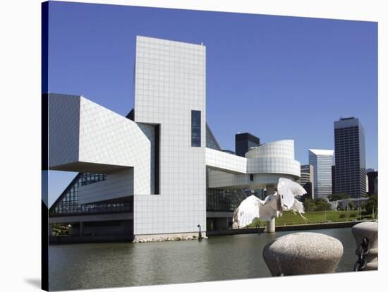 A Ring-Billed Gull Takes Flight in Front of the Rock and Roll Hall of Fame and Museum-null-Stretched Canvas