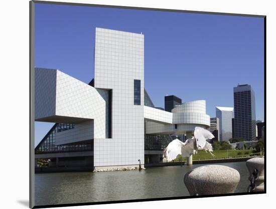 A Ring-Billed Gull Takes Flight in Front of the Rock and Roll Hall of Fame and Museum-null-Mounted Photographic Print