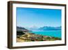 A road winds along the edge of a turquoise blue lake with mountains in the distance, New Zealand-Logan Brown-Framed Photographic Print