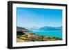 A road winds along the edge of a turquoise blue lake with mountains in the distance, New Zealand-Logan Brown-Framed Photographic Print