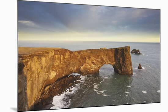 A rock arch on Dyrholaey Island seen in sunset sunlight, near Vik, south coast of Iceland-Nigel Hicks-Mounted Photographic Print