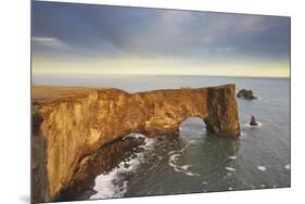 A rock arch on Dyrholaey Island seen in sunset sunlight, near Vik, south coast of Iceland-Nigel Hicks-Mounted Photographic Print