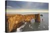 A rock arch on Dyrholaey Island seen in sunset sunlight, near Vik, south coast of Iceland-Nigel Hicks-Stretched Canvas