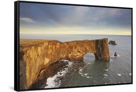 A rock arch on Dyrholaey Island seen in sunset sunlight, near Vik, south coast of Iceland-Nigel Hicks-Framed Stretched Canvas