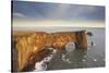 A rock arch on Dyrholaey Island seen in sunset sunlight, near Vik, south coast of Iceland-Nigel Hicks-Stretched Canvas