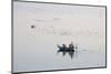 A rowing boat  surrounded by birds carries two novice monks towards U-Bein bridge on Taungthaman La-Tim Mannakee-Mounted Photographic Print