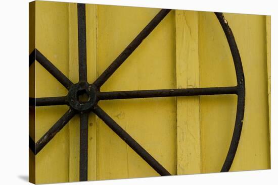 A Rusty Wheel from a Deck Is Nailed to an Outdoor Wall in Key West, Florida-Sergio Ballivian-Stretched Canvas