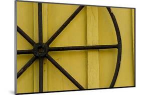 A Rusty Wheel from a Deck Is Nailed to an Outdoor Wall in Key West, Florida-Sergio Ballivian-Mounted Photographic Print