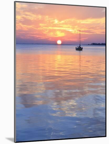 A Sailboat Silhouetted against a Brilliant Sunset in a Cove off Pensacola Bay, Florida-Colin D Young-Mounted Photographic Print