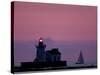 A Sailboat Slips Past a Lighthouse as the Sunset Comes to Lake Erie off the Coast of Cleveland-null-Stretched Canvas