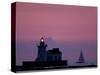 A Sailboat Slips Past a Lighthouse as the Sunset Comes to Lake Erie off the Coast of Cleveland-null-Stretched Canvas