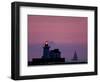 A Sailboat Slips Past a Lighthouse as the Sunset Comes to Lake Erie off the Coast of Cleveland-null-Framed Photographic Print