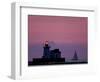 A Sailboat Slips Past a Lighthouse as the Sunset Comes to Lake Erie off the Coast of Cleveland-null-Framed Photographic Print