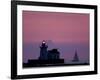 A Sailboat Slips Past a Lighthouse as the Sunset Comes to Lake Erie off the Coast of Cleveland-null-Framed Photographic Print