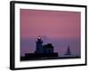 A Sailboat Slips Past a Lighthouse as the Sunset Comes to Lake Erie off the Coast of Cleveland-null-Framed Photographic Print