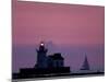 A Sailboat Slips Past a Lighthouse as the Sunset Comes to Lake Erie off the Coast of Cleveland-null-Mounted Photographic Print