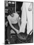 A Sailor in the Tailor Shop Aboard a US Navy Cruiser Checking Uniform Trousers of Another Sailor-null-Mounted Photographic Print