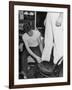 A Sailor in the Tailor Shop Aboard a US Navy Cruiser Checking Uniform Trousers of Another Sailor-null-Framed Photographic Print