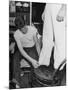 A Sailor in the Tailor Shop Aboard a US Navy Cruiser Checking Uniform Trousers of Another Sailor-null-Mounted Photographic Print