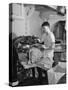 A Sailor Pressing Uniform Trousers in the Tailor Shop of a US Navy Cruiser-null-Stretched Canvas