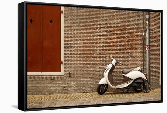 A Scooter Parked on the Sidewalk Outside of Oude Kerk Church in Amsterdam, Netherlands-Carlo Acenas-Framed Stretched Canvas