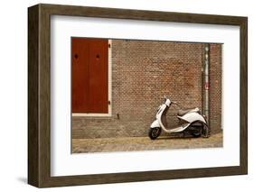 A Scooter Parked on the Sidewalk Outside of Oude Kerk Church in Amsterdam, Netherlands-Carlo Acenas-Framed Photographic Print