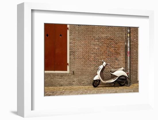 A Scooter Parked on the Sidewalk Outside of Oude Kerk Church in Amsterdam, Netherlands-Carlo Acenas-Framed Photographic Print