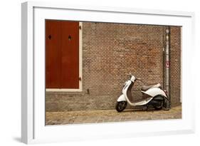 A Scooter Parked on the Sidewalk Outside of Oude Kerk Church in Amsterdam, Netherlands-Carlo Acenas-Framed Photographic Print