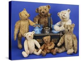 A Selection of Teddy Bears around a Black Painted Tinplate Toy Stove-null-Stretched Canvas