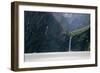 A sightseeing ship dwarfed by a tall waterfall in a fjord, South Island, New Zealand, Pacific-Logan Brown-Framed Photographic Print