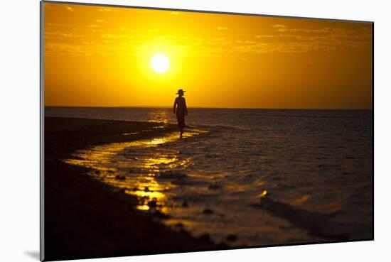 A Silhouette of a Woman Walking in the Waves of the Surf at Sunset in Holbox Island, Mexico-Karine Aigner-Mounted Photographic Print